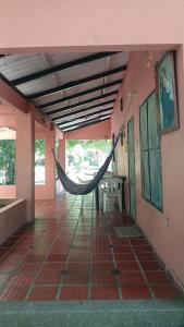 a room with a hammock in the middle of a building at Hospedaje Eden in Los Naranjos