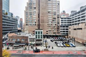 a city with cars parked in a parking lot at Hudson Yards 1br w gym wd nr penn station NYC-1308 in New York