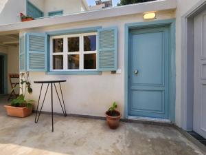 a house with a blue door and a table at Railway House 2BR Apt w front yard in Beirut