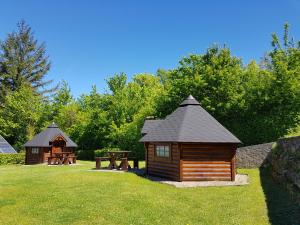 a small cabin and a picnic table in the grass at Camping Officiel Wollefsschlucht Echternach in Echternach