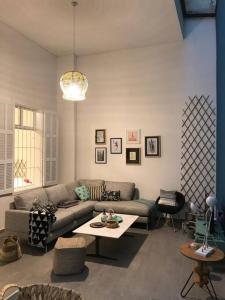 a living room with a couch and a table at Skylight 1BR Apartment Mar Mikhael in Beirut