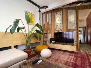 a living room with a couch and a flat screen tv at Designer 1BR apt in Gemmayze in Beirut