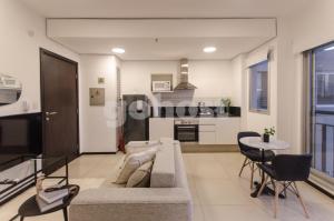 een woonkamer met een bank en een tafel bij Wonderful Studio In The City, Close To Sh Del Sol in Asuncion
