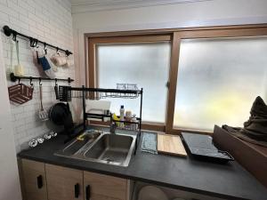 a kitchen with a sink and a window at Wizard House in Seoul in Seoul