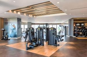 a gym with treadmills and exercise equipment in a building at Skyline Serenity 2BR Haven in Dubai