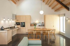a kitchen with a table and chairs in a room at Clementine in Dorchester