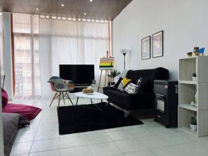 a living room with a couch and a table at Artist Nest In Getaoui, Achrafieh in Beirut