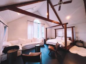 a attic room with a bed and a couch at The Land - Retreat Center In Beautiful Nature - Bay Area Northern California in Philo +91 photos