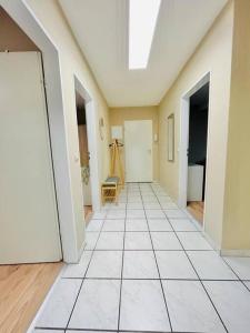 an empty hallway with white tile floors and a skylight at Dortmund City Wohnung 85/7 in Dortmund