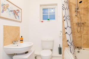 a bathroom with a white toilet and a sink at Cosy Two Bedroom Apartment in Crewe, Free Parking in Crewe