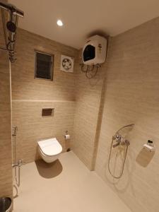 a bathroom with a shower and a toilet and a shower at Hotel Monsoon Palace Guwahati in Guwahati