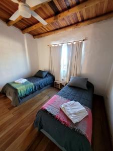 a bedroom with two beds and a ceiling at Pindó III in Concordia