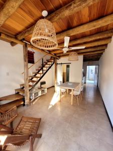 a dining room with a table and a wooden ceiling at Pindó III in Concordia