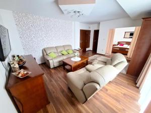 a living room with two couches and a table at Penzión Stavbet in Svidník