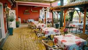 a restaurant with tables and chairs and red walls at Gasthof Engel in Müllheim