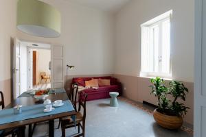 a living room with a red couch and a table at Cappelluti 1924 in Matera