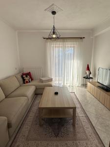 a living room with a couch and a coffee table at Living Home Trikala in Tríkala