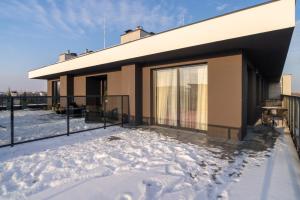 a house in the snow with a balcony at ApartamentySnu, Bulwary IV z parkingiem in Radom