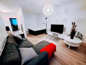 a living room with a couch and a tv at Spacious Northern City Apartment in Rovaniemi