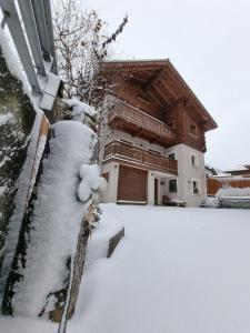 a house covered in snow in front at Casa Al Rin in Valdidentro