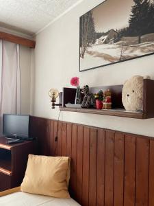 a bedroom with a bed and a desk with a teddy bear at Kábrtova bouda in Janske Lazne