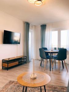 a living room with a table and a dining room at Apartment- Metzingen in Metzingen