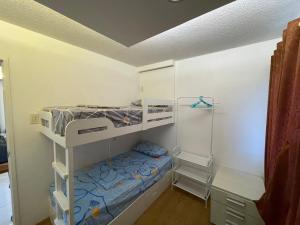 a bedroom with two bunk beds and a shower at Cozy 2-bedroom Condo at Marcos Highway in Manila