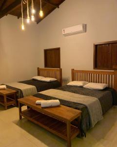 a hotel room with two beds and a table at Sítio Barriguda in Alexânia