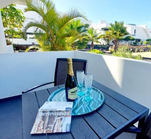 a bottle of champagne and two glasses on a table at Casa Ana - Luxury pool apartment at Casilla de Costa in Villaverde