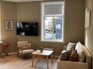 a living room with a couch and a window at Moss Hotel & Apartments in Moss