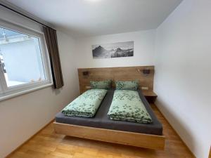 a bedroom with a bed and a window at Ferienwohnung Laura in Wald am Arlberg