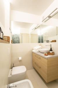a bathroom with a toilet and a sink and a mirror at Agave Marina in Marciana Marina +167 photos