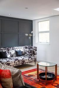 a living room with a couch and a table at Birch South Lanes - Super 2 bed duplex with south terrace in Brighton & Hove