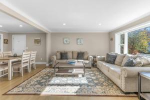 a living room with a couch and a table at Cozy Spacious Home Walk to the Beach and 1 Mile to Downtown Hyannis in Barnstable