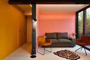 a living room with a couch and two chairs at NEOZONE Neostudio Malmedy in Malmedy