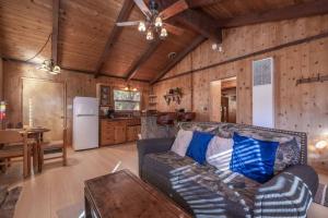 a living room with a couch and a kitchen at Donut Chalet with spa, BBQ grill, and firepit in Big Bear Lake