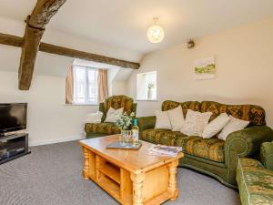 a living room with a couch and a coffee table at 2 Bed in Combe Martin 86938 in Berrynarbor
