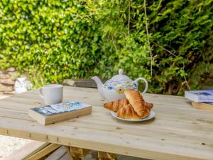 a table with a teapot and croissants and a cup of tea at 2 Bed in Combe Martin 86938 in Berrynarbor