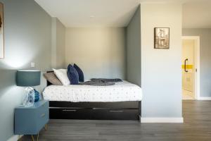 a bedroom with a bed and a blue nightstand at Brand New Large Studio in Sheffield