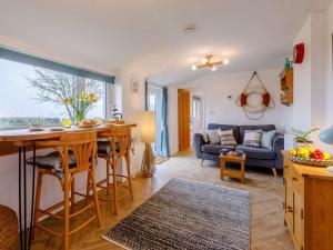 a kitchen and living room with a table and a couch at 1 Bed in Braunton 86987 in Braunton