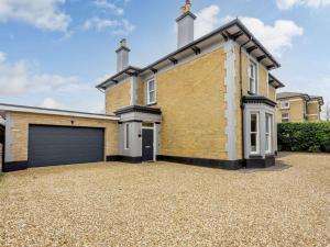 a large brick house with a garage at 5 Bed in Sandown 87008 in Sandown