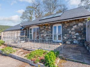 a stone house with a porch and a window at 2 bed property in Bala 86963 in Llandderfel