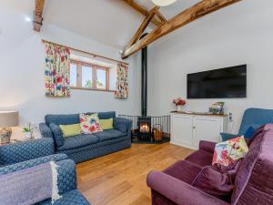 a living room with two couches and a tv at 4 Bed in Church Stretton 87695 in Cardington