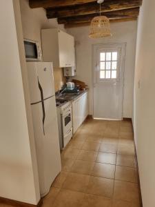 a kitchen with a white refrigerator and a window at Pindó III in Concordia