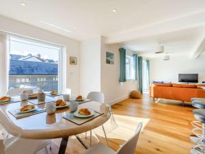 a dining room with a table and white chairs at 3 Bed in Bude 87256 in Bude
