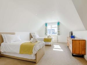 a bedroom with two beds and a dresser at 3 Bed in Bude 87256 in Bude
