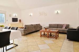 a living room with couches and a coffee table at U Paesolu in Sainte-Lucie de Porto-Vecchio