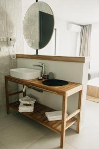 a bathroom with a sink and a mirror at Luuma in 2 Mai