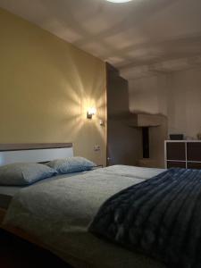 a bedroom with a bed and a light on the wall at Turm Hämelmaous in Echternach