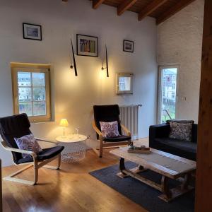 a living room with two chairs and a coffee table at Turm Hämelmaous in Echternach